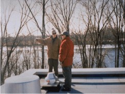 Two men inspecting insulation on a commercial rooftop, from the company archives